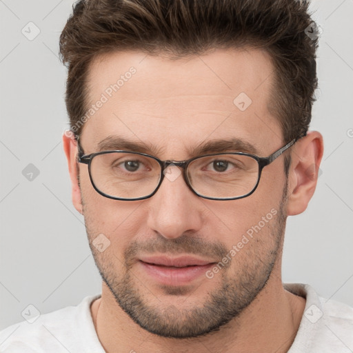 Joyful white young-adult male with short  brown hair and grey eyes