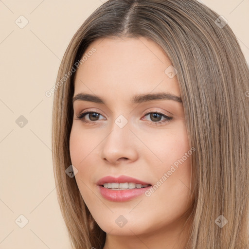 Joyful white young-adult female with long  brown hair and brown eyes