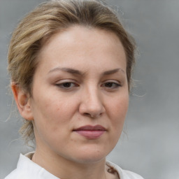 Joyful white adult female with medium  brown hair and grey eyes