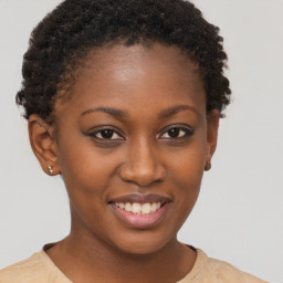 Joyful black young-adult female with short  brown hair and brown eyes