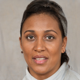 Joyful black adult female with short  brown hair and brown eyes