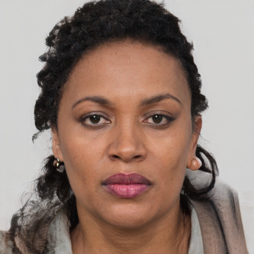 Joyful black adult female with short  brown hair and brown eyes