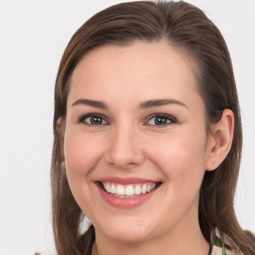 Joyful white young-adult female with long  brown hair and grey eyes