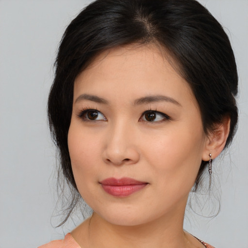 Joyful asian young-adult female with medium  brown hair and brown eyes