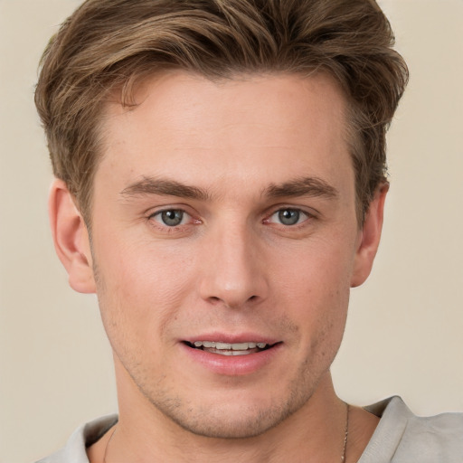 Joyful white young-adult male with short  brown hair and grey eyes