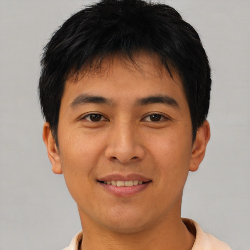 Joyful asian young-adult male with short  black hair and brown eyes