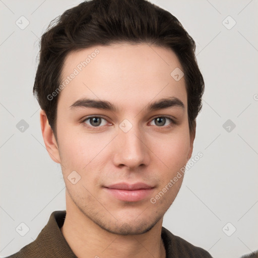 Joyful white young-adult male with short  brown hair and grey eyes