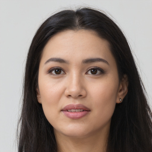 Joyful latino young-adult female with long  brown hair and brown eyes