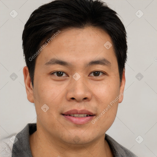 Joyful asian young-adult male with short  brown hair and brown eyes