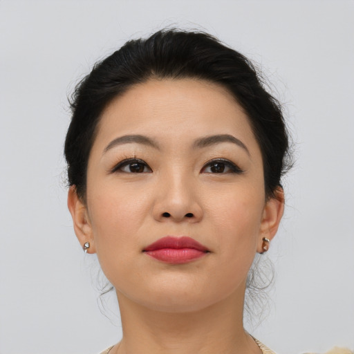 Joyful asian young-adult female with medium  brown hair and brown eyes