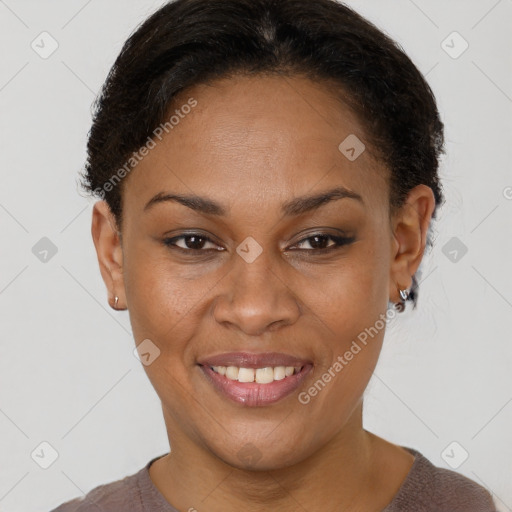 Joyful black adult female with short  brown hair and brown eyes