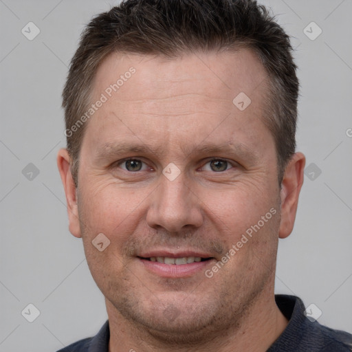 Joyful white adult male with short  brown hair and brown eyes