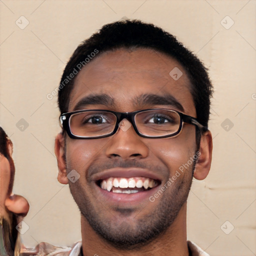 Joyful white young-adult male with short  black hair and brown eyes