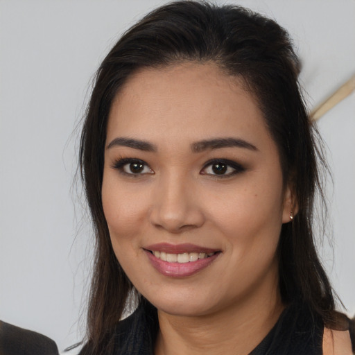 Joyful white young-adult female with long  brown hair and brown eyes