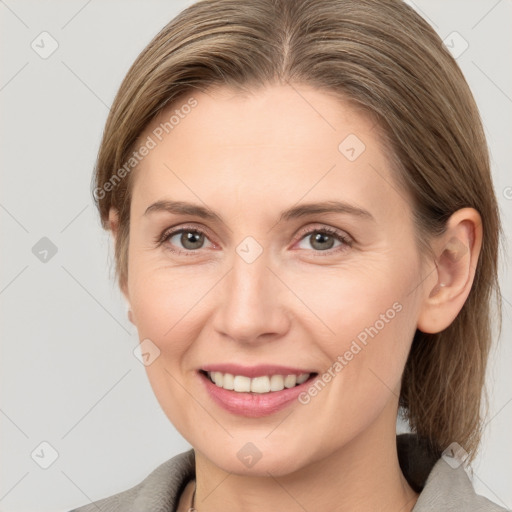 Joyful white adult female with medium  brown hair and grey eyes