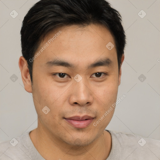 Joyful asian young-adult male with short  brown hair and brown eyes