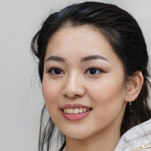 Joyful white young-adult female with medium  black hair and brown eyes