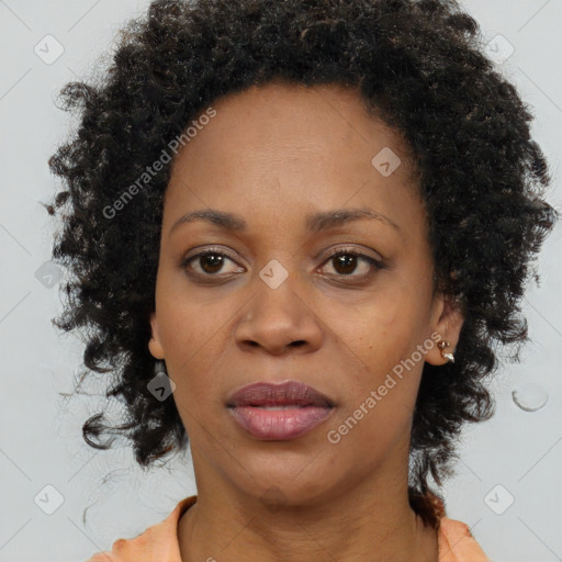 Joyful black adult female with medium  brown hair and brown eyes