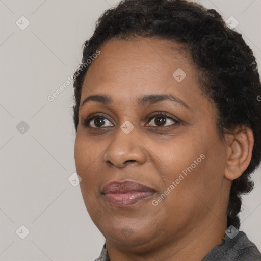 Joyful black adult female with short  brown hair and brown eyes