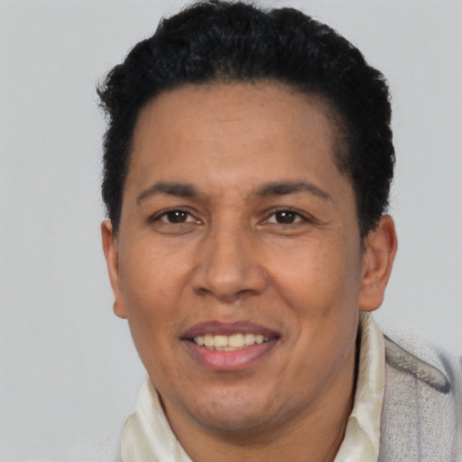 Joyful latino adult male with short  brown hair and brown eyes