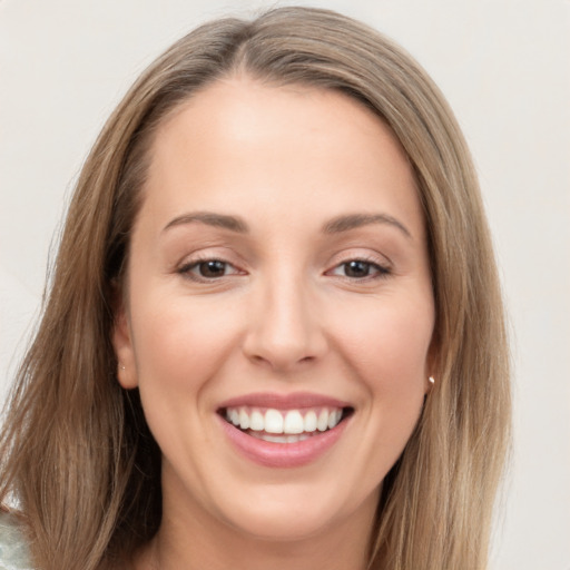 Joyful white young-adult female with long  brown hair and brown eyes