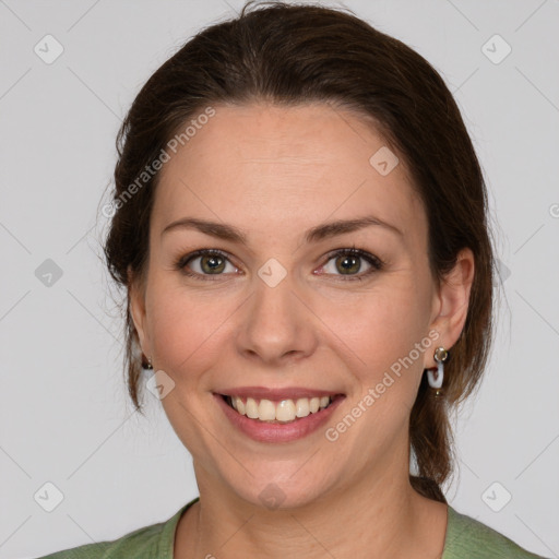 Joyful white adult female with medium  brown hair and green eyes