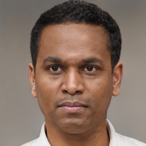 Neutral latino adult male with short  black hair and brown eyes