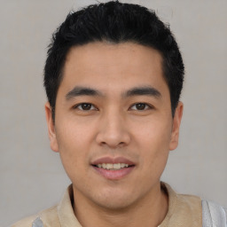 Joyful asian young-adult male with short  black hair and brown eyes