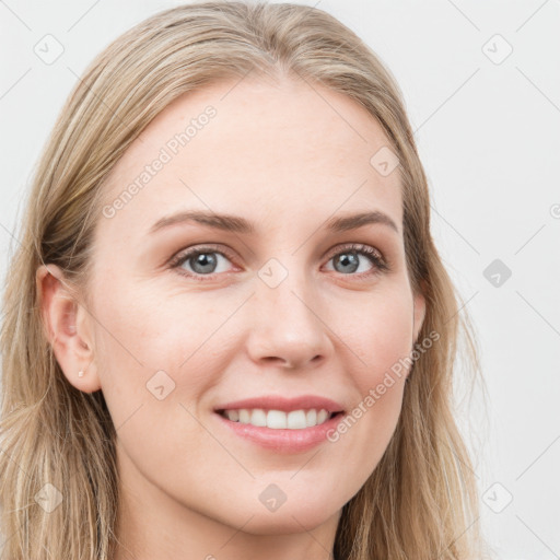 Joyful white young-adult female with long  brown hair and blue eyes