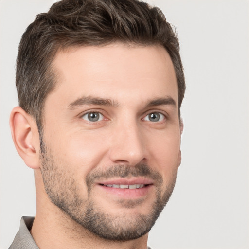 Joyful white young-adult male with short  brown hair and brown eyes