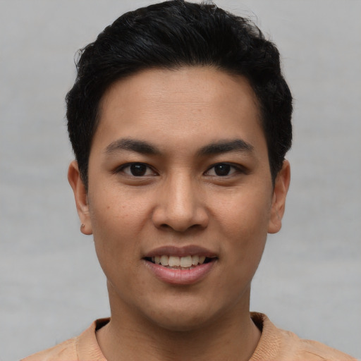 Joyful asian young-adult male with short  black hair and brown eyes