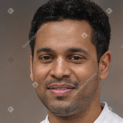 Joyful black young-adult male with short  black hair and brown eyes