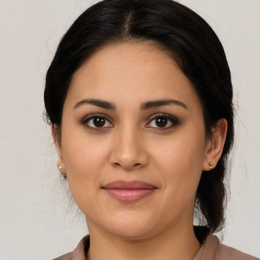 Joyful latino young-adult female with medium  black hair and brown eyes