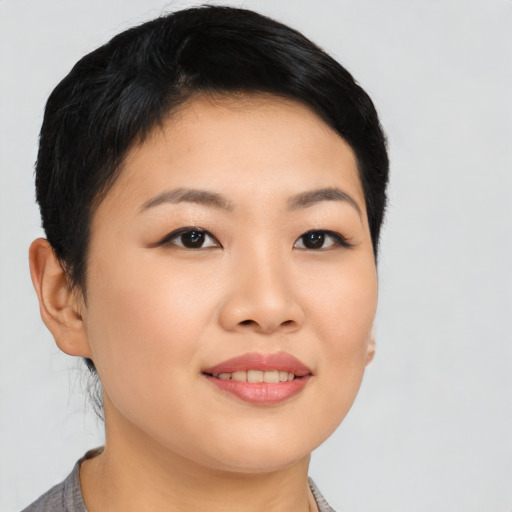 Joyful asian young-adult female with short  black hair and brown eyes