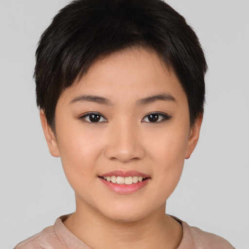 Joyful asian young-adult female with short  brown hair and brown eyes