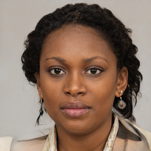 Neutral black young-adult female with medium  brown hair and brown eyes
