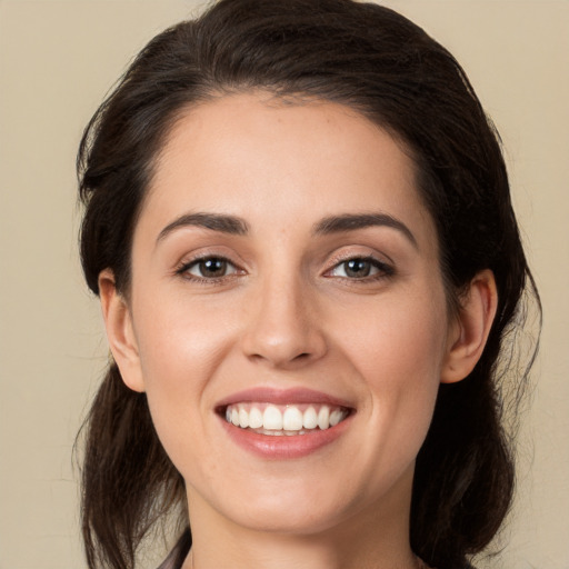 Joyful white young-adult female with medium  brown hair and brown eyes