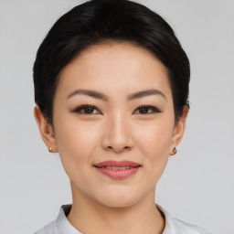 Joyful asian young-adult female with short  black hair and brown eyes