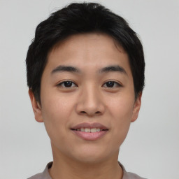 Joyful asian young-adult male with short  brown hair and brown eyes