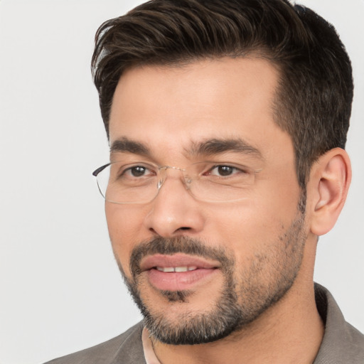 Joyful white young-adult male with short  black hair and brown eyes