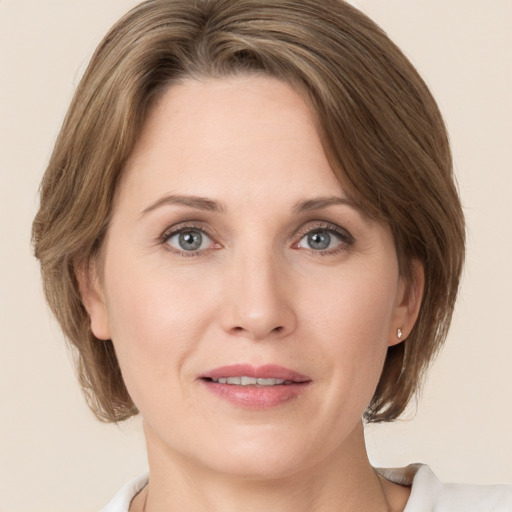 Joyful white young-adult female with medium  brown hair and green eyes