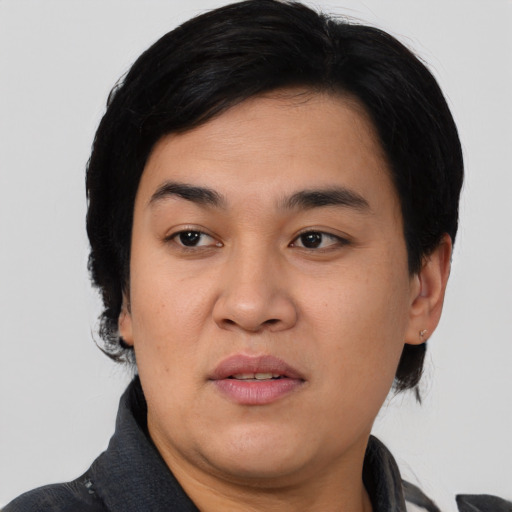 Joyful asian young-adult female with short  black hair and brown eyes