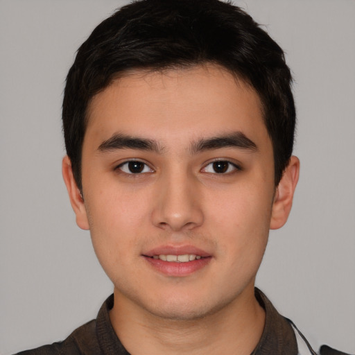 Joyful asian young-adult male with short  brown hair and brown eyes
