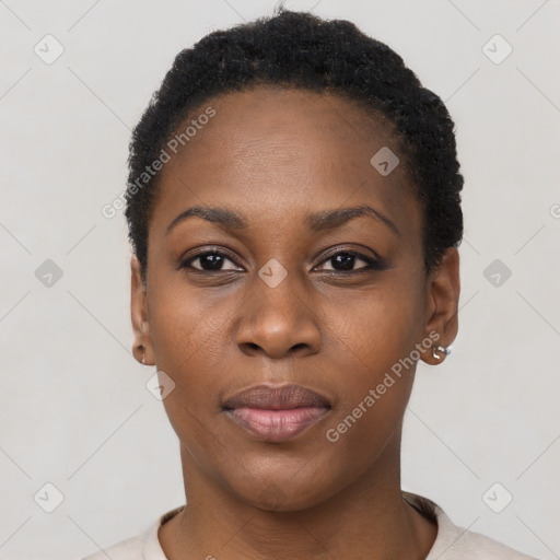 Joyful black young-adult female with short  black hair and brown eyes