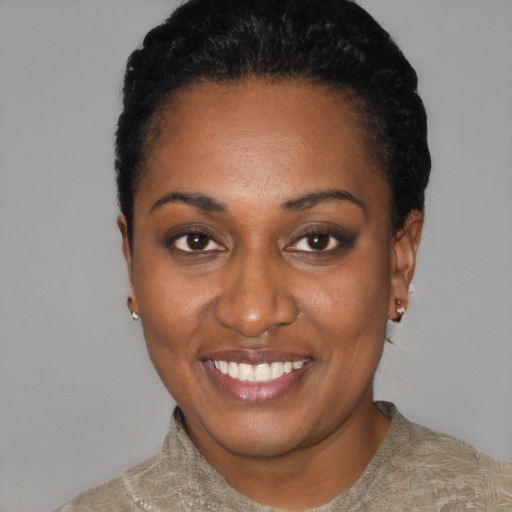 Joyful black young-adult female with short  black hair and brown eyes