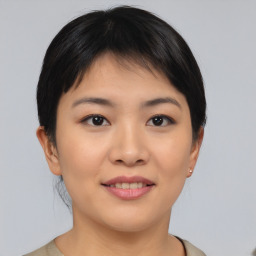 Joyful asian young-adult female with short  brown hair and brown eyes