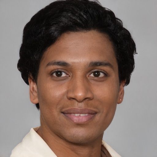 Joyful latino young-adult male with short  brown hair and brown eyes
