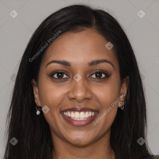 Joyful black young-adult female with long  brown hair and brown eyes