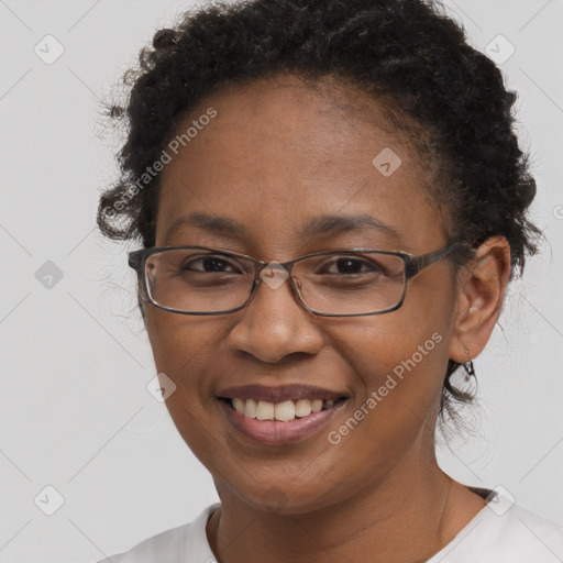 Joyful black adult female with short  brown hair and brown eyes