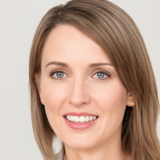 Joyful white young-adult female with medium  brown hair and green eyes